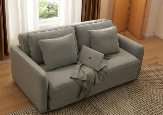 Durable sofa in light gray with decorative pillows and a laptop, suitable for everyday living