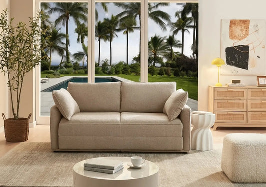 Premium durability sofa in beige with rolled armrests overlooking tropical pool and gardens