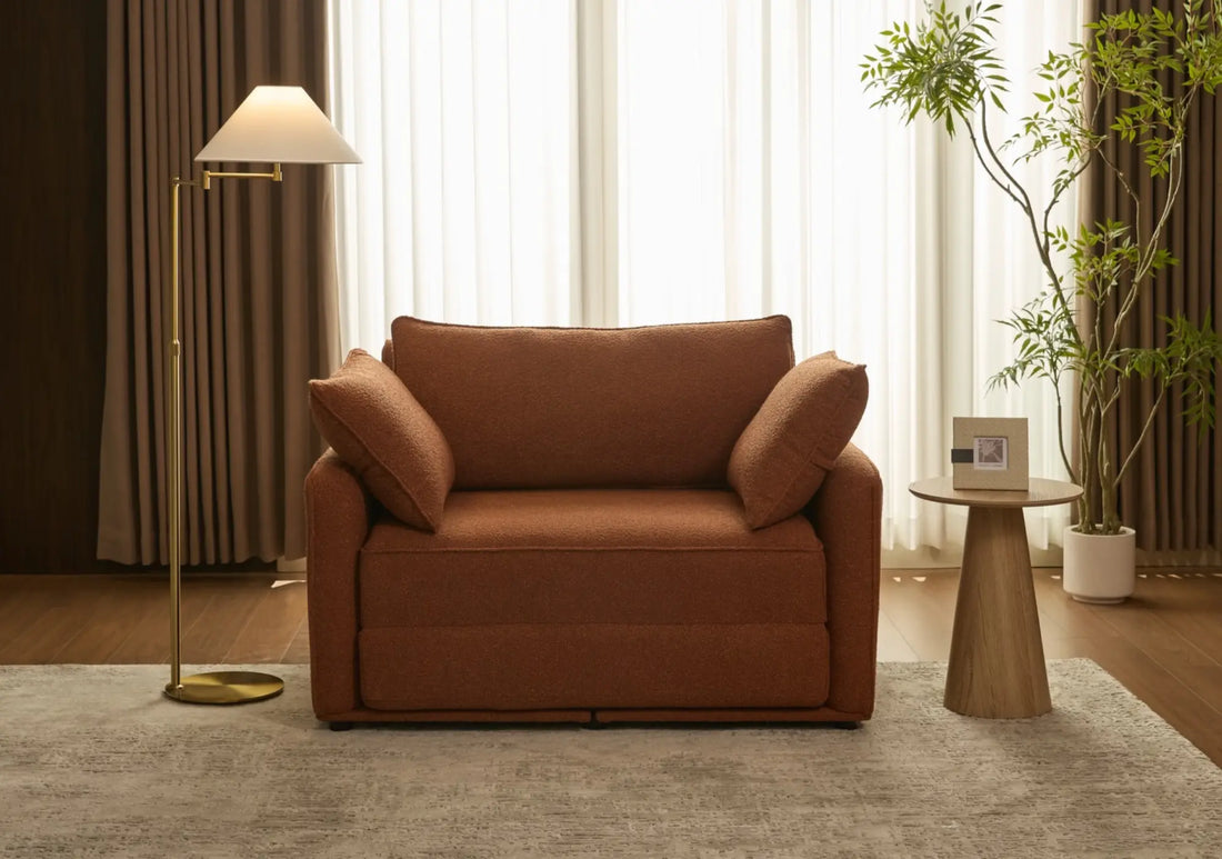 Sophisticated rust-brown sofa with rolled arms in an elegantly styled room with modern furnishings