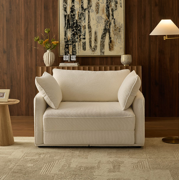 Cream boucle Sunset Sofa Bed styled in a walnut-paneled living room with abstract art.