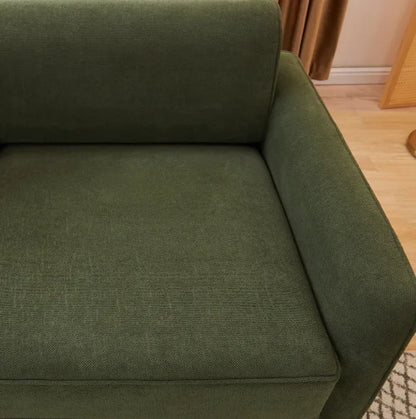 Close-up of woven olive green fabric on the seat and armrest of the Sunset Sofa Bed.
