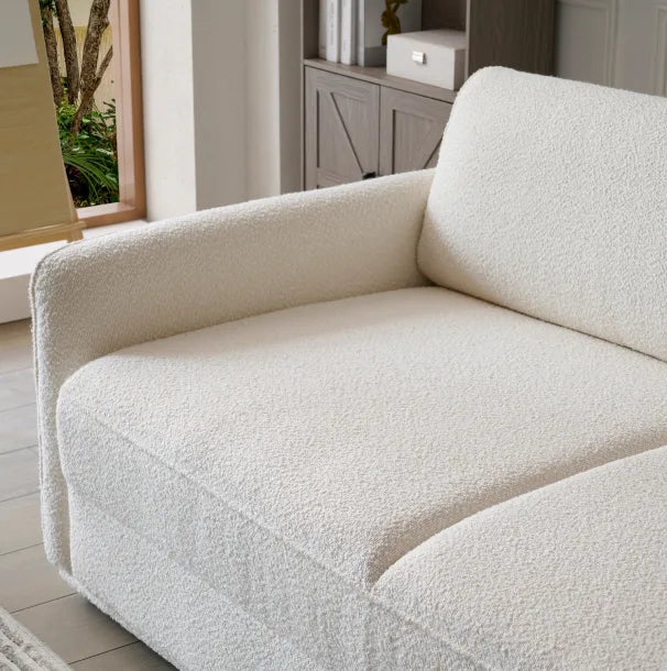 Cream boucle Sunset Sofa Bed close-up showing textured fabric in a sunlit living room.