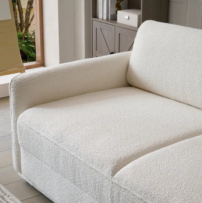 Cream boucle Sunset Sofa Bed close-up showing textured fabric in a sunlit living room.